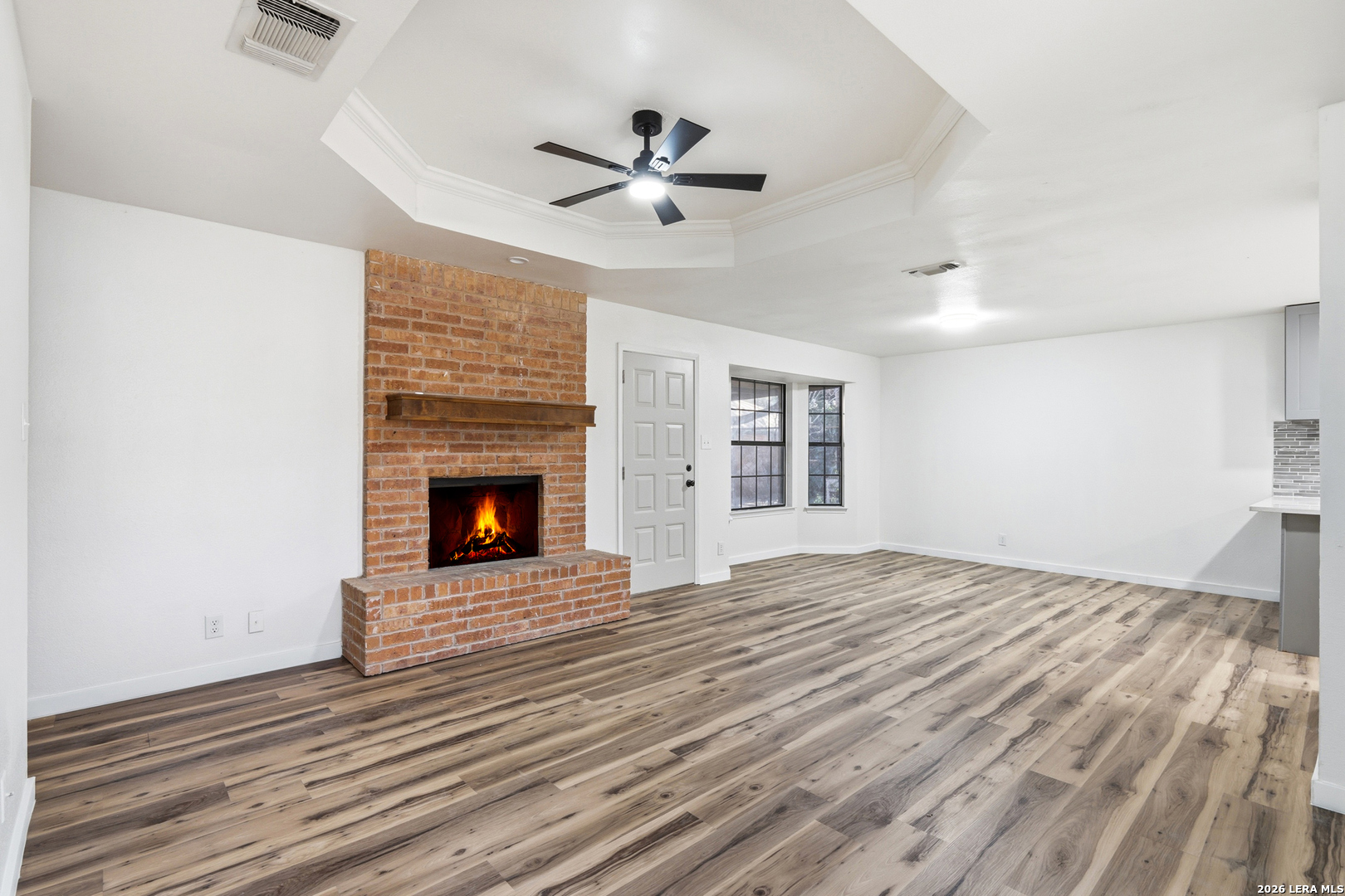 1300 Cyrus Schertz, TX 78154 - Photo 6 of 30 a view of an empty room with wooden floor fireplace and a window