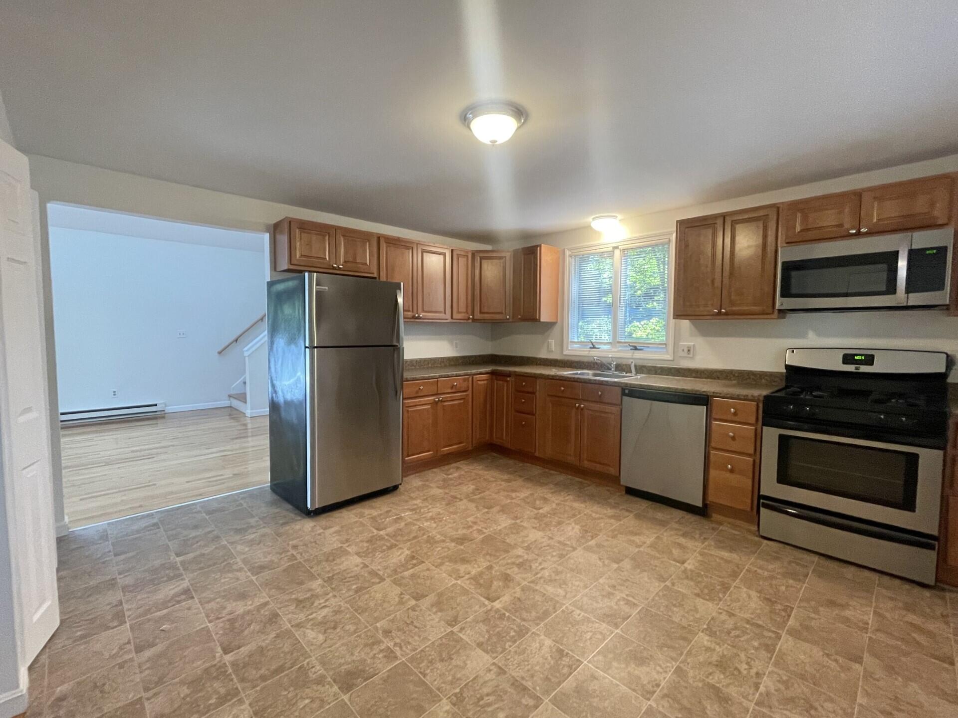 23 Radcliffe Road Mashpee, MA 02649 - Photo 5 of 20 a kitchen with stainless steel appliances granite countertop a refrigerator and a stove top oven