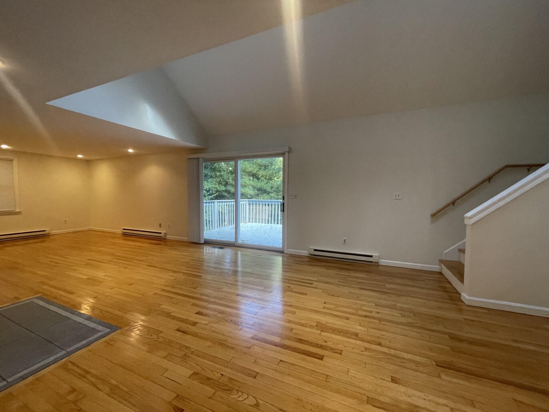 23 Radcliffe Road Mashpee, MA 02649 - Photo 6 of 20 a view of an empty room with wooden floor and a window
