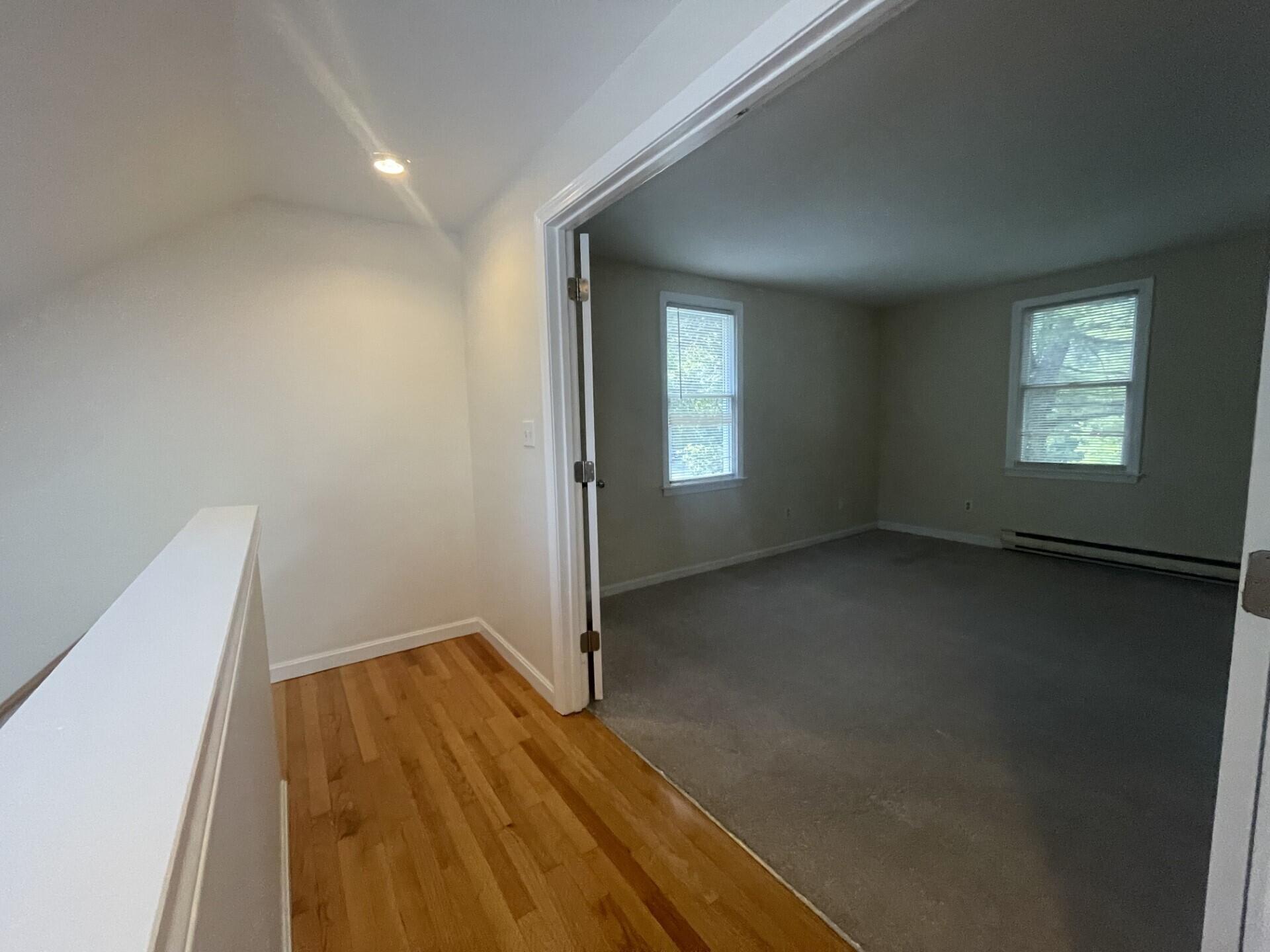 23 Radcliffe Road Mashpee, MA 02649 - Photo 10 of 20 an empty room with wooden floor and windows