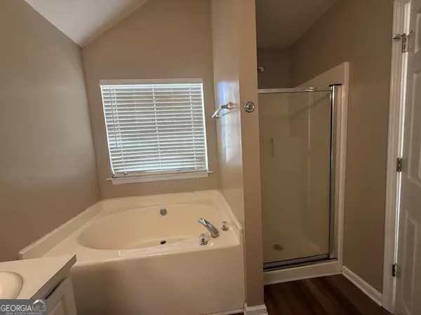a bathroom with a bathtub and a window