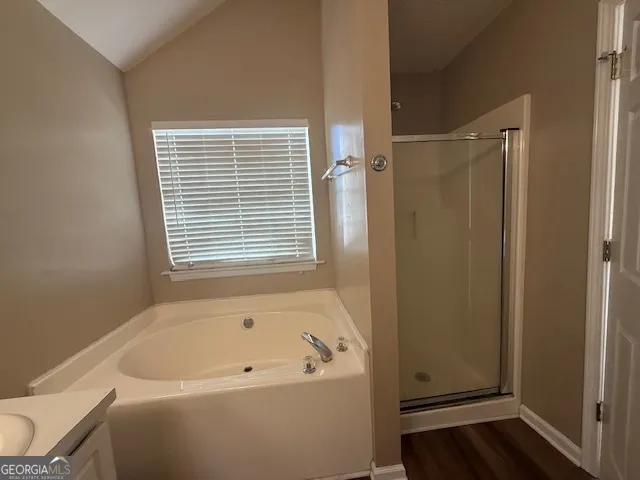 a bathroom with a bathtub and a window