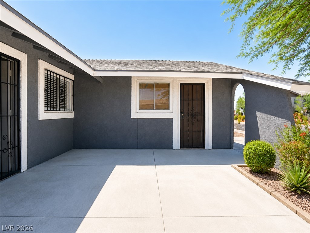 2870 South Sandhill Road Las Vegas, NV 89121 - Photo 7 of 64 A welcoming entry area with clean concrete leads to a home featuring stucco siding.