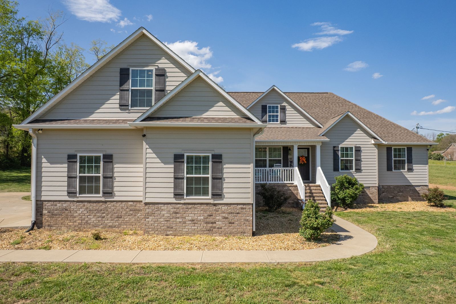 a front view of a house with a yard
