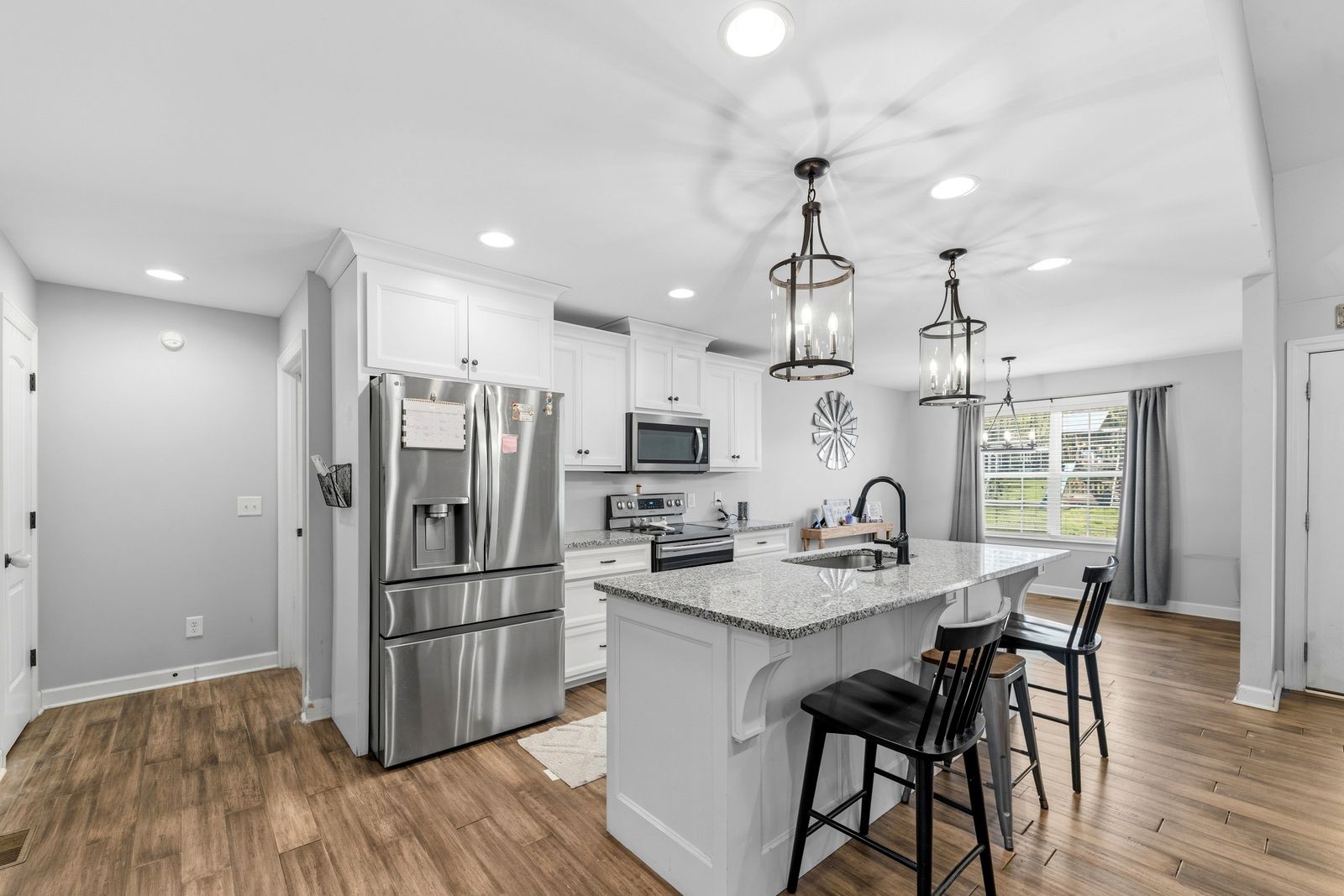 3036 Valley Creek Road Culleoka, TN 38451 - Photo 19 of 56 a kitchen with refrigerator cabinets dining table and chairs