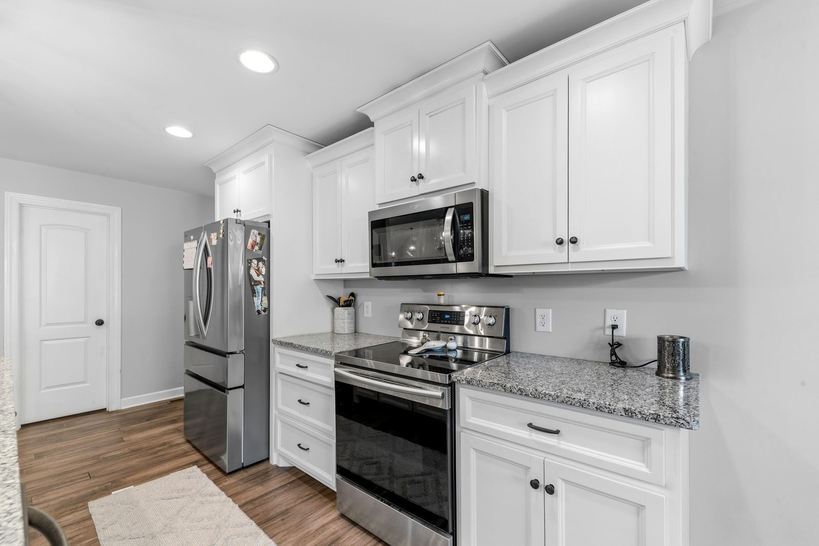 3036 Valley Creek Road Culleoka, TN 38451 - Photo 20 of 56 a kitchen with stainless steel appliances granite countertop a stove a refrigerator and a microwave