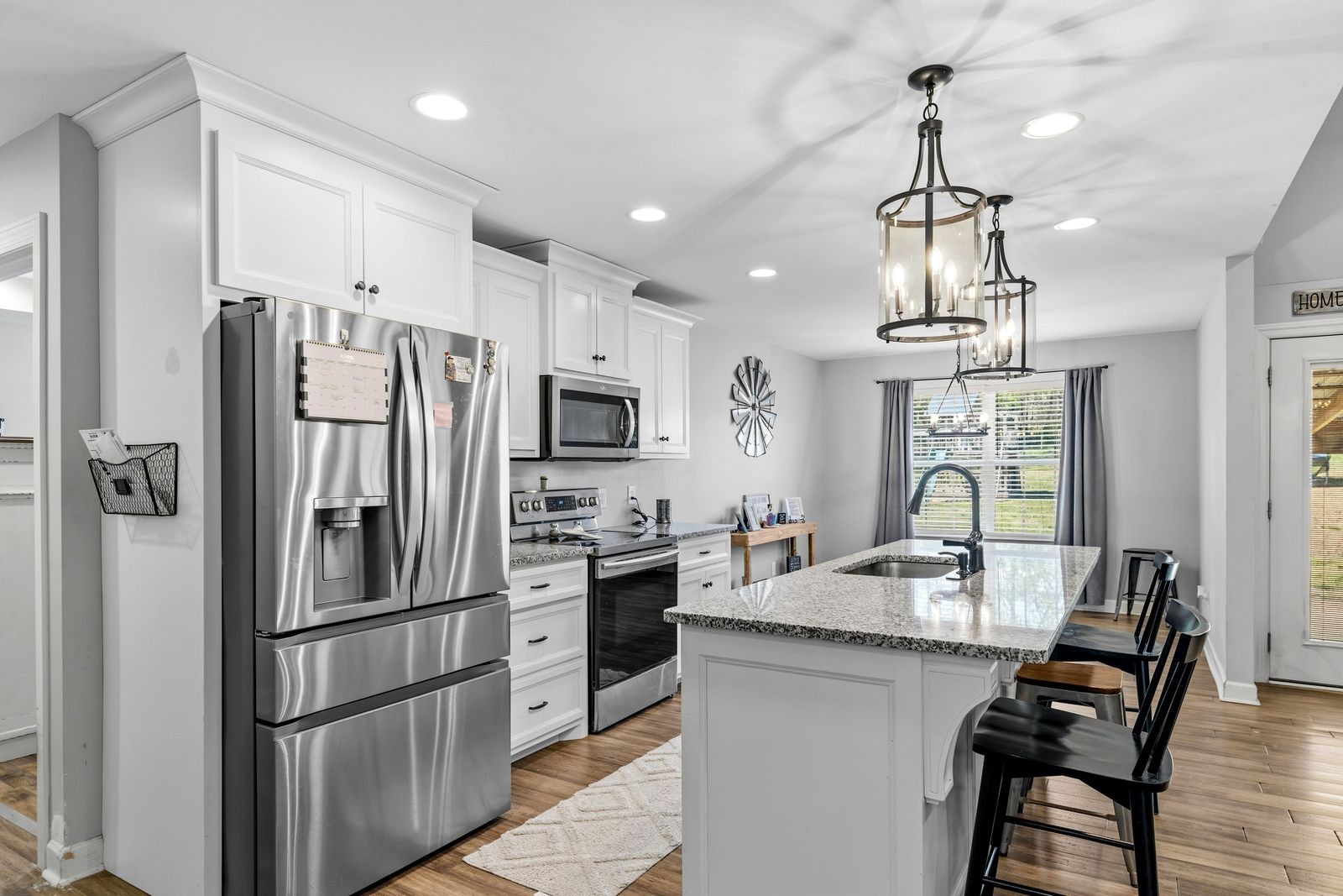 3036 Valley Creek Road Culleoka, TN 38451 - Photo 21 of 56 a kitchen with stainless steel appliances a dining table chairs stove and refrigerator