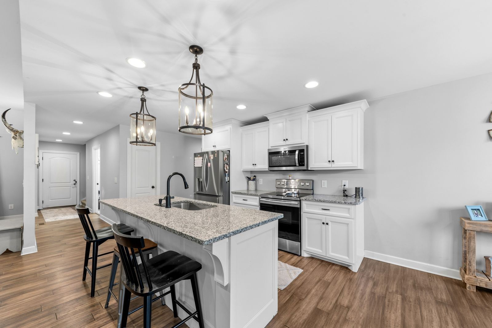 3036 Valley Creek Road Culleoka, TN 38451 - Photo 24 of 56 a kitchen with stainless steel appliances granite countertop a kitchen island a stove a table and chairs in it