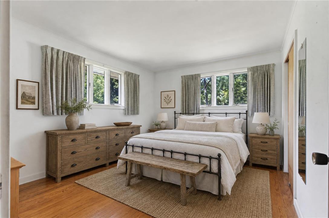 51 Reynolds Road Tamaqua, PA 18252 - Photo 39 of 71 Relax in this tranquil bedroom, featuring a large bed, hardwood flooring, and ample natural light from multiple windows.