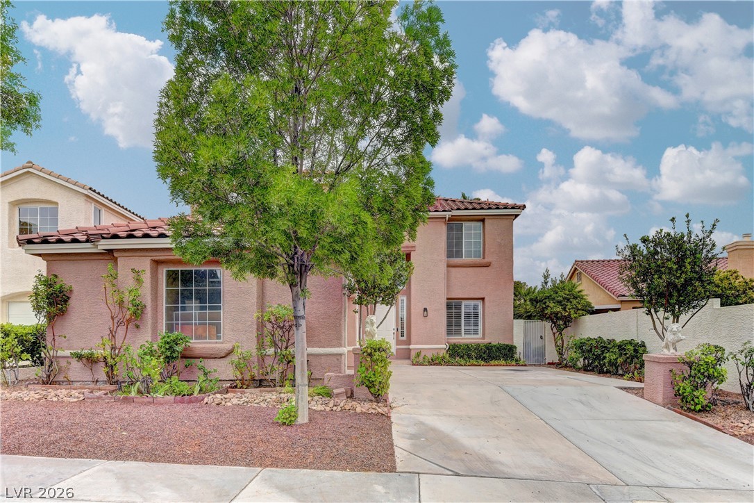 1813 Snow Spring Lane Las Vegas, NV 89134 - Photo 1 of 37 A terracotta-hued facade with Mediterranean tile roofing creates inviting curb appeal.