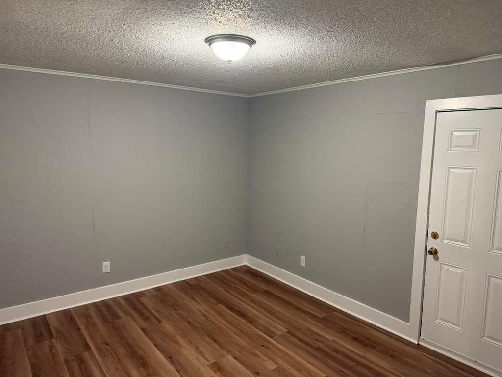 1010 University Street Memphis, TN 38107 - Photo 11 of 17 a view of room with wooden floor