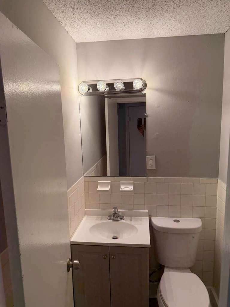 1010 University Street Memphis, TN 38107 - Photo 5 of 17 a bathroom with a toilet sink and mirror