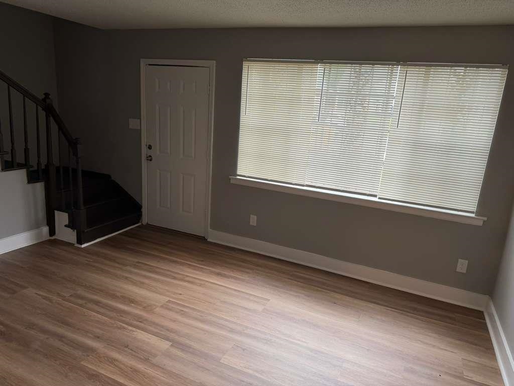 1010 University Street Memphis, TN 38107 - Photo 7 of 17 a view of an empty room with wooden floor and a window
