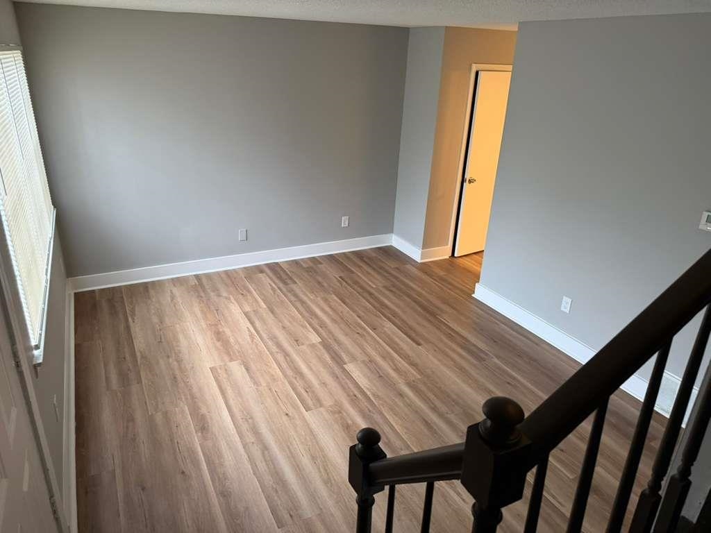 1010 University Street Memphis, TN 38107 - Photo 8 of 17 a view of an empty room with wooden floor and a window