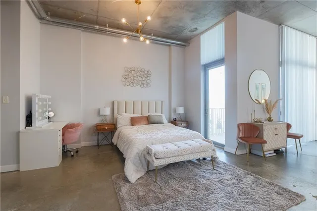 a bedroom with a bed and a chandelier