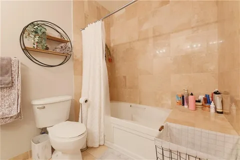 a bathroom with a toilet a sink and mirror