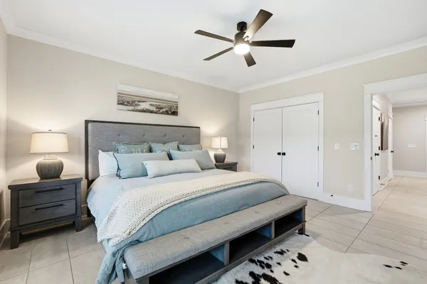 a bedroom with a large bed and a rug