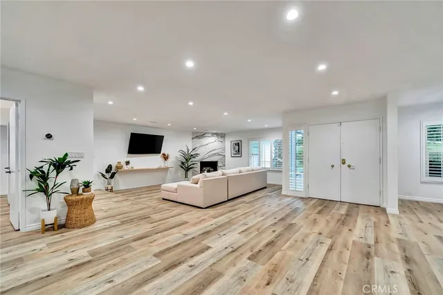 a kitchen with stainless steel appliances a dining table chairs and a refrigerator