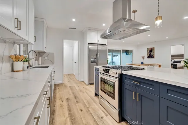 a spacious bedroom with a bed and a flat screen tv