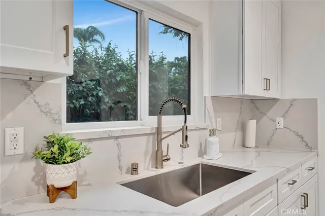 a bathroom with a granite countertop toilet sink and mirror
