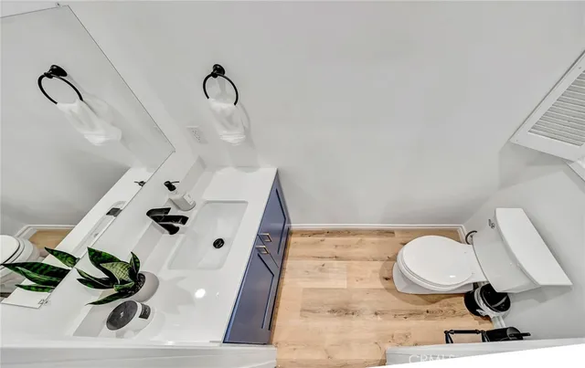 a spacious bedroom with a bed and a flat screen tv