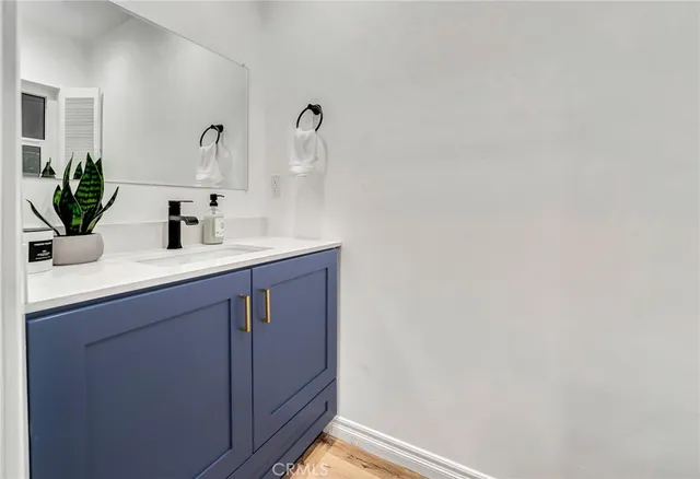 a bathroom with a granite countertop sink a mirror and a shower