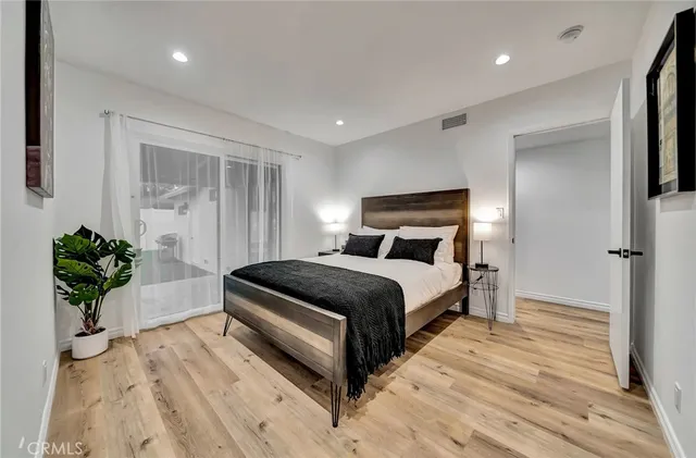 a spacious bedroom with a bed and a desk