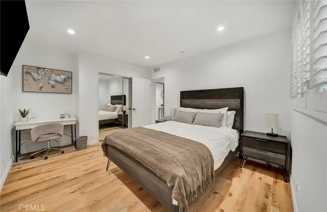 a spacious bedroom with a bed and a desk