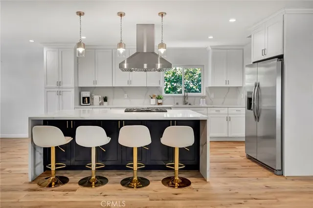 a kitchen with kitchen island granite countertop a sink a center island and cabinets