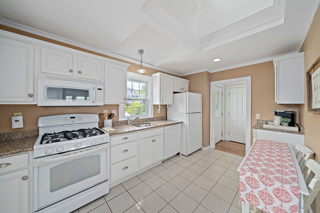 77 Jefferson Shores Road Wareham, MA 02532 - Photo 11 of 34 a kitchen with granite countertop a sink stove and cabinets
