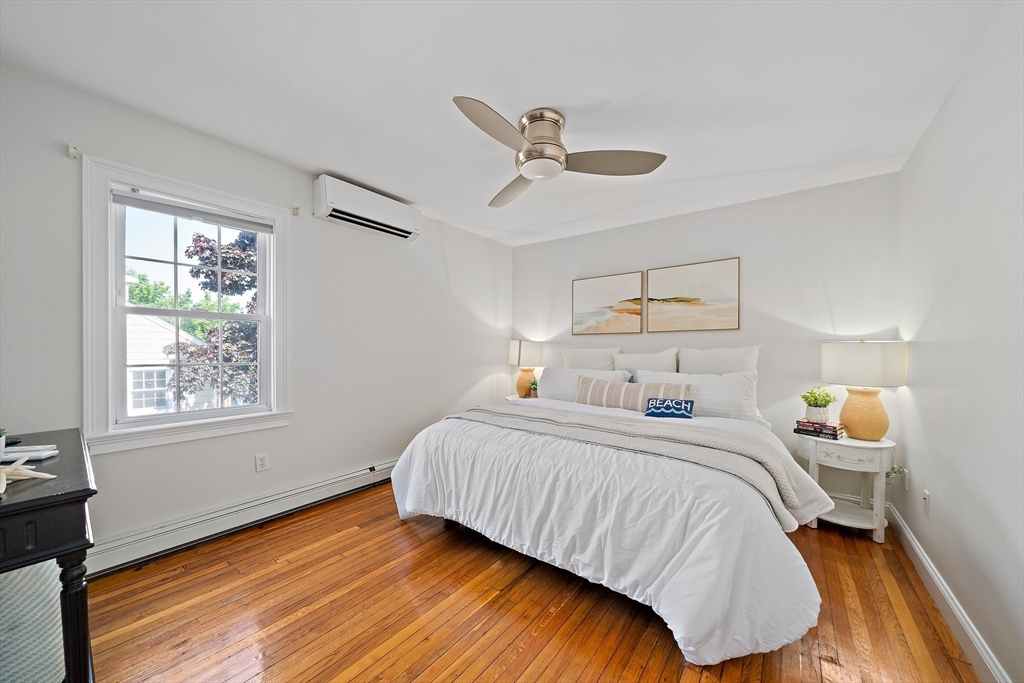 77 Jefferson Shores Road Wareham, MA 02532 - Photo 13 of 34 a bedroom with a bed and wooden floor