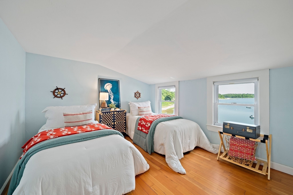 77 Jefferson Shores Road Wareham, MA 02532 - Photo 18 of 34 a bedroom with a bed and wooden floor