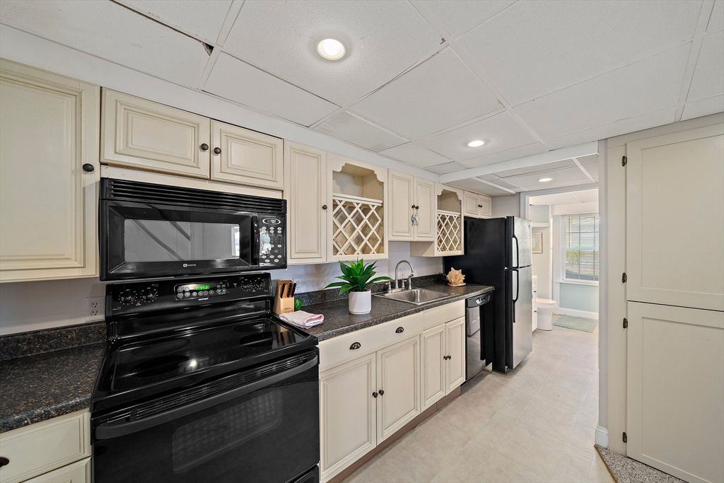 77 Jefferson Shores Road Wareham, MA 02532 - Photo 28 of 34 a kitchen with stainless steel appliances kitchen island granite countertop a stove and a refrigerator