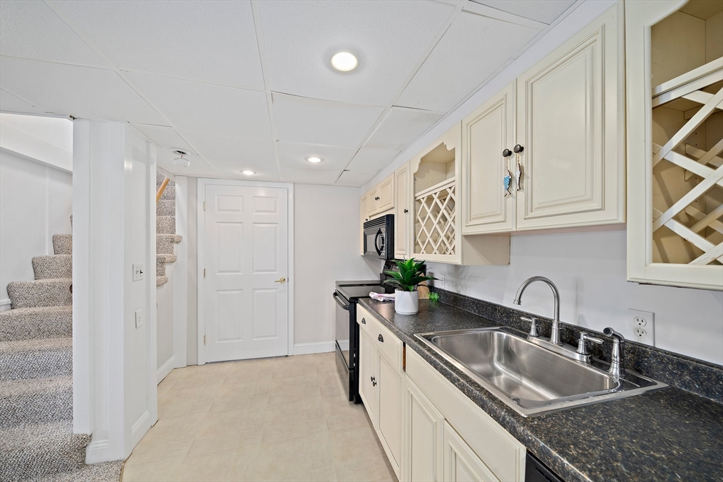 77 Jefferson Shores Road Wareham, MA 02532 - Photo 29 of 34 a kitchen with stainless steel appliances granite countertop a sink and cabinets