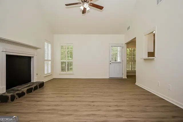 wooden floor in an empty room with a window