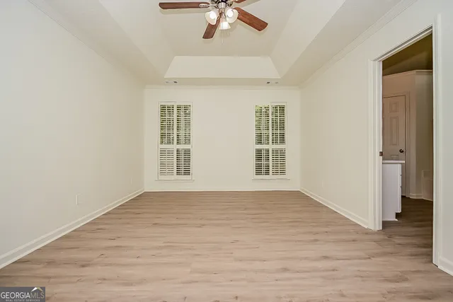 wooden floor in an empty room with a window