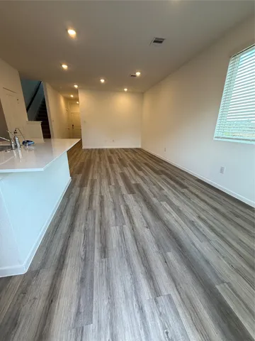 a view of kitchen counter top space and wooden floor