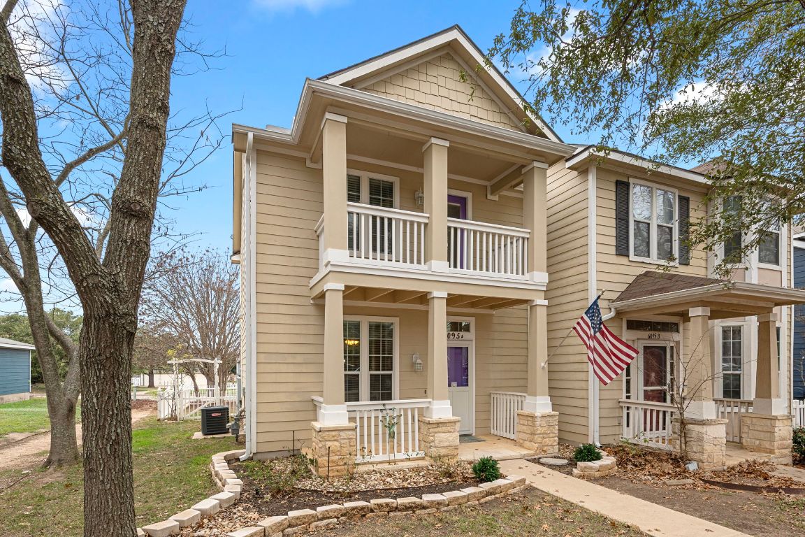 a front view of a house with a tree