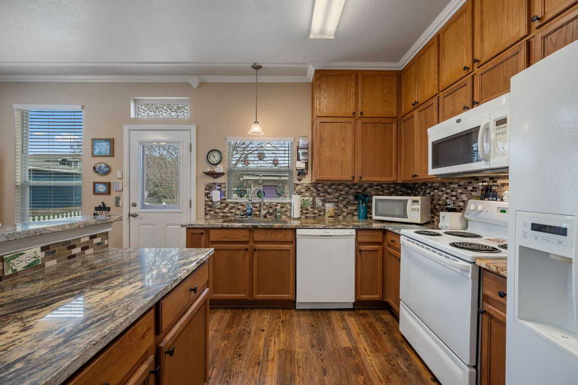 6095 Negley, Unit A Kyle, TX 78640 - Photo 11 of 40 a kitchen with stainless steel appliances granite countertop a sink stove and refrigerator