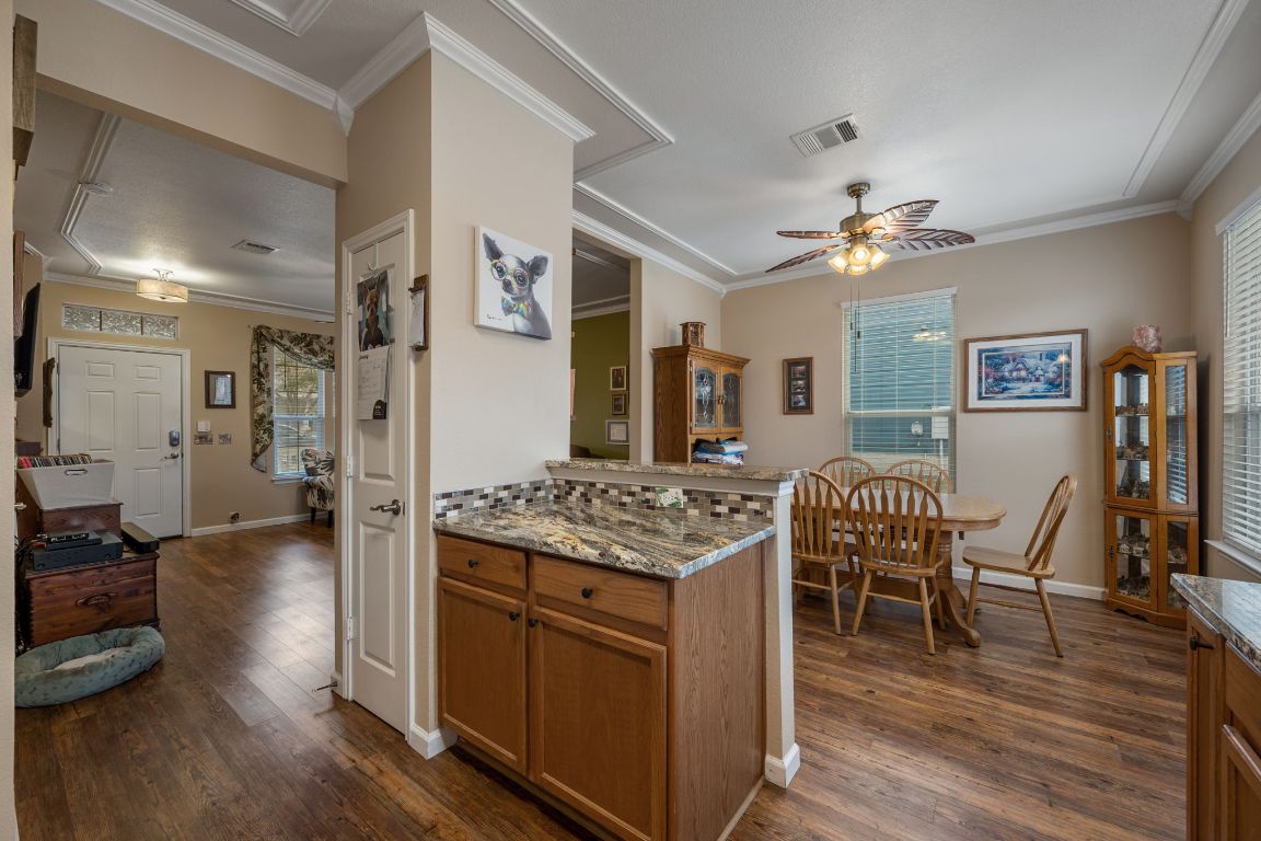 6095 Negley, Unit A Kyle, TX 78640 - Photo 13 of 40 a view of a kitchen counter space and wooden floor