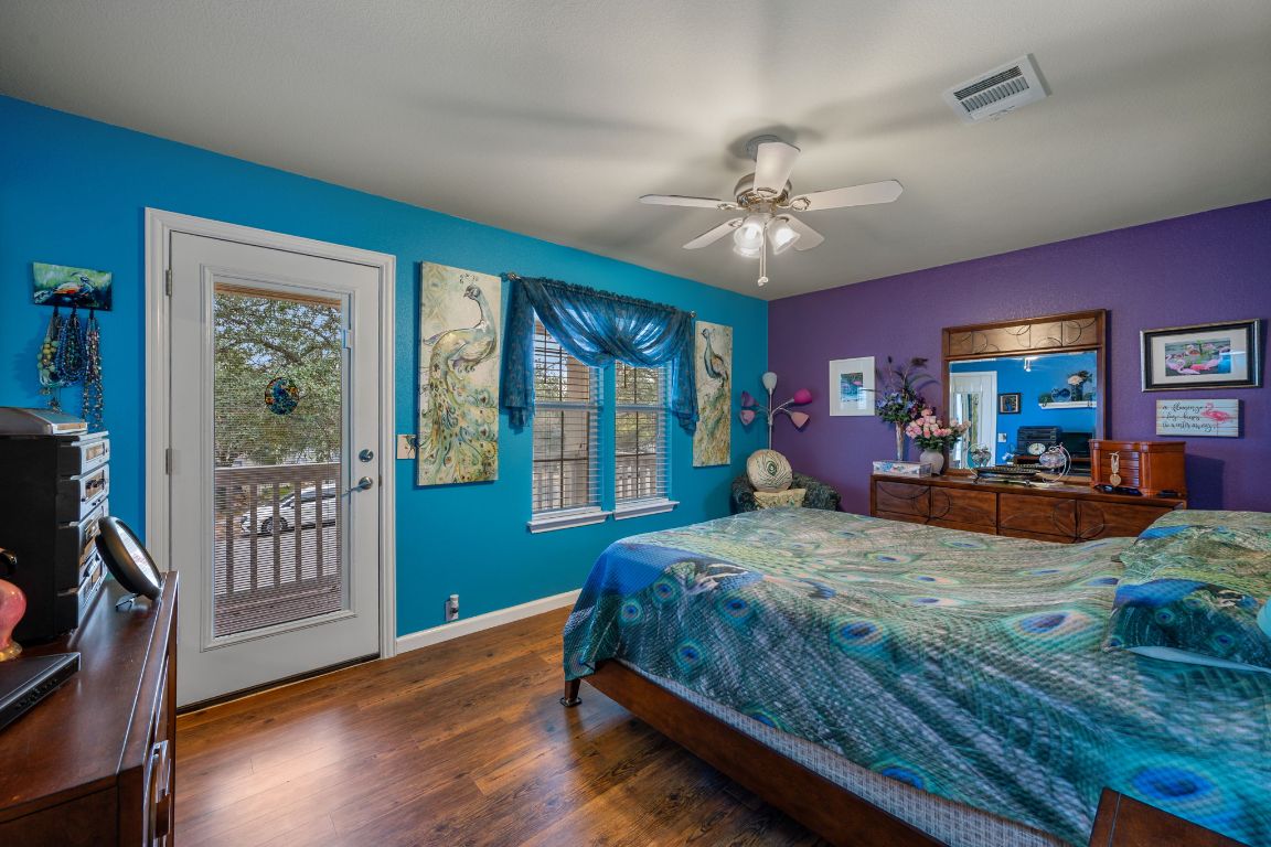 6095 Negley, Unit A Kyle, TX 78640 - Photo 15 of 40 a bedroom with a large bed chandelier and a window