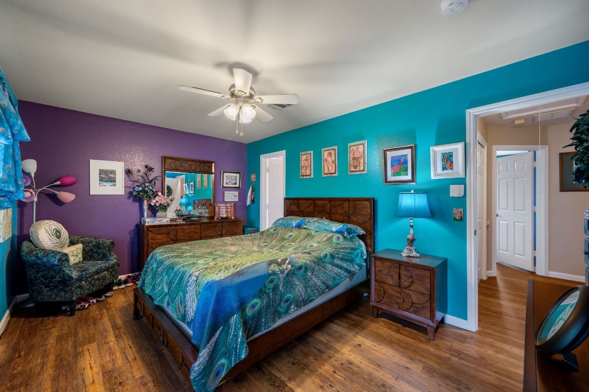 6095 Negley, Unit A Kyle, TX 78640 - Photo 16 of 40 a bedroom with a bed bookshelf and a large window