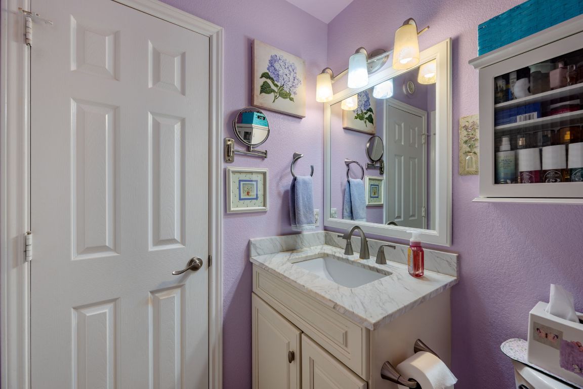 6095 Negley, Unit A Kyle, TX 78640 - Photo 19 of 40 a bathroom with a granite countertop sink and a mirror