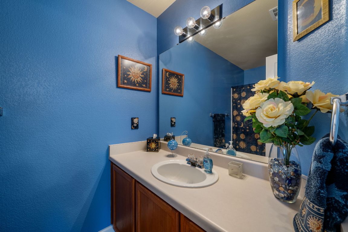 6095 Negley, Unit A Kyle, TX 78640 - Photo 24 of 40 a bathroom with a sink vanity and a mirror
