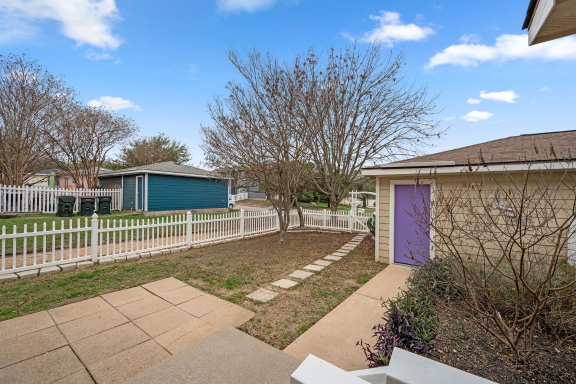 6095 Negley, Unit A Kyle, TX 78640 - Photo 30 of 40 a front view of a house with a yard and garage