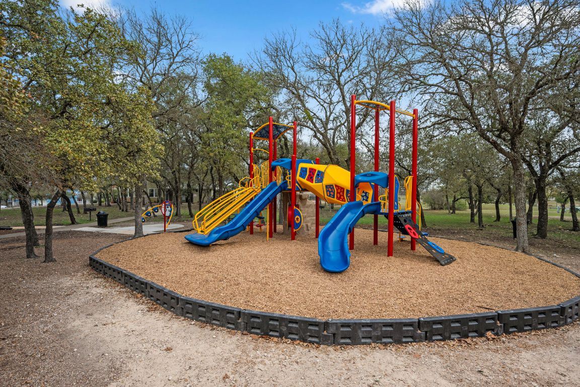6095 Negley, Unit A Kyle, TX 78640 - Photo 33 of 40 a view of a park with swings and slides