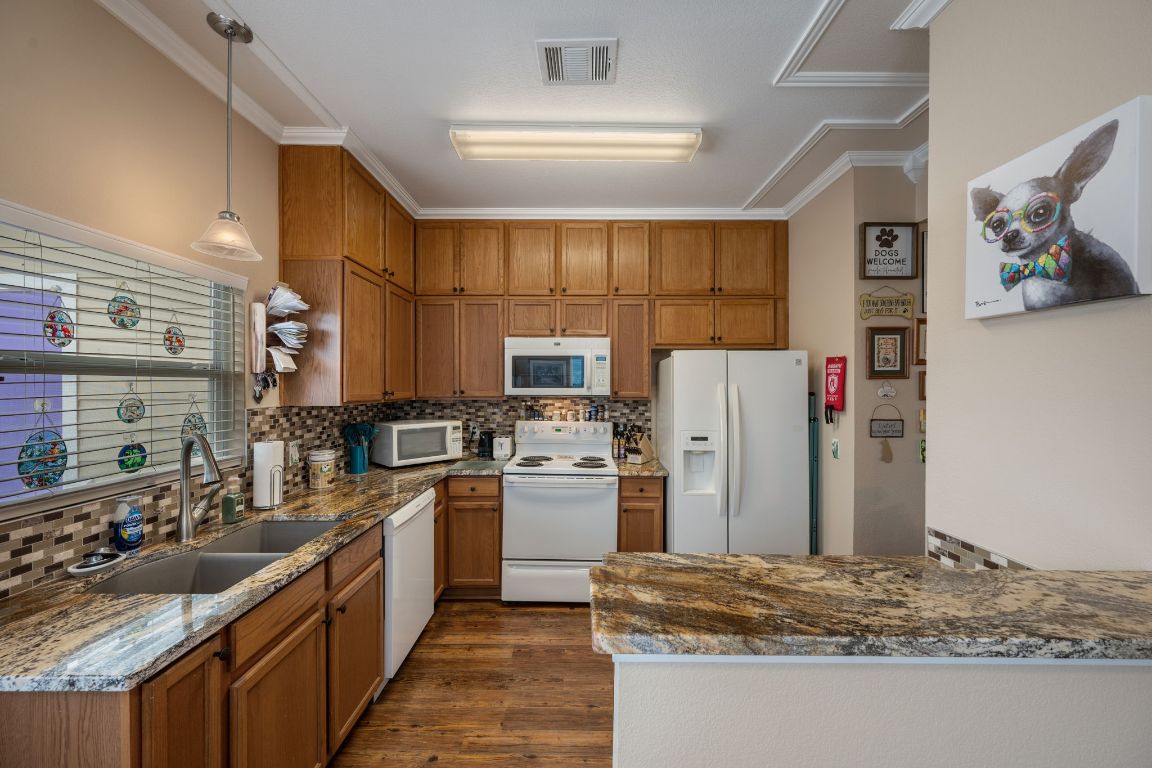 6095 Negley, Unit A Kyle, TX 78640 - Photo 9 of 40 a kitchen with refrigerator and cabinets