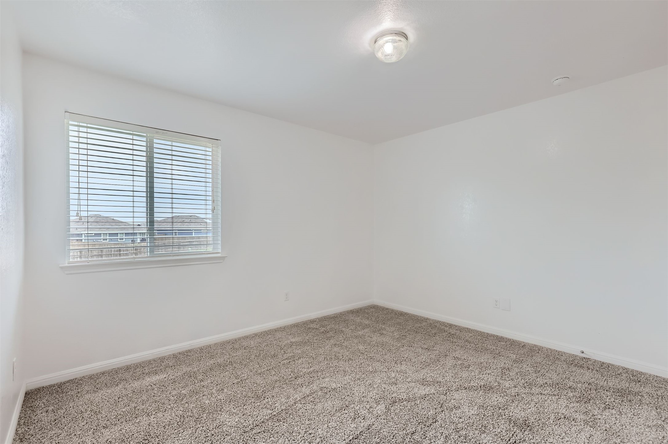 131 Lavaca Loop Hutto, TX 78634 - Photo 18 of 29 A well-lit bedroom offering a blank canvas for personalization.