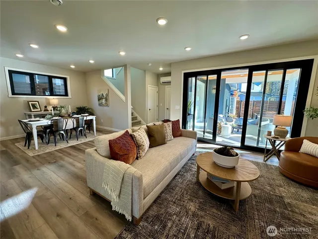 a living room with furniture and large windows