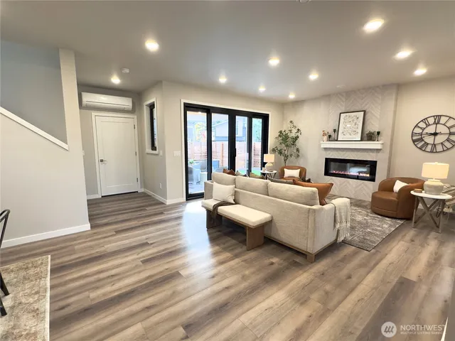 a living room with fireplace furniture and a wooden floor